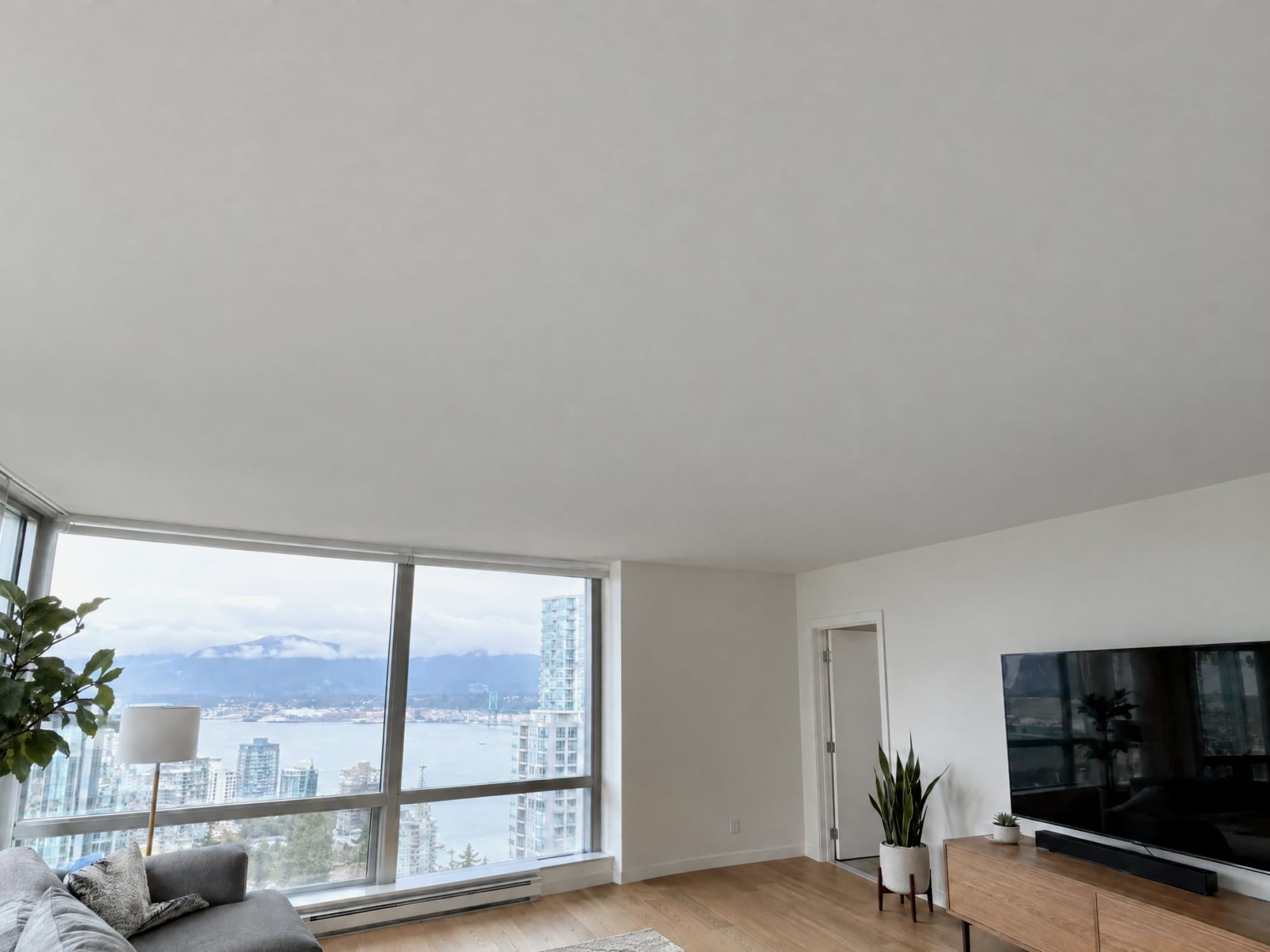 The same ceiling repaired: flat, smooth and freshly painted white with no visible patch
